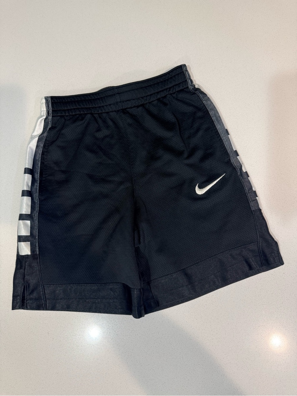 Nike Black Athletic Mesh Shorts with White Swoosh and Side Accents